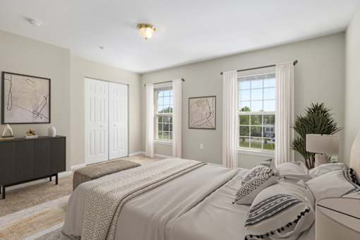 A bedroom with a large bed and a dresser.